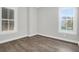 Bright bedroom with hardwood floors and two windows providing ample natural light at 779 Forrest Dr, Charleston, SC 29492