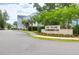 Street view of community entrance sign with lush landscaping and community homes beyond at 779 Forrest Dr, Charleston, SC 29492