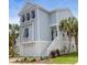 Attractive light blue home with white trim, garage, and landscaped yard at 779 Forrest Dr, Charleston, SC 29492