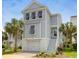 Charming elevated home with garage, staircase, palm trees, and neutral color scheme at 779 Forrest Dr, Charleston, SC 29492