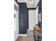 Stylish hallway with dark blue walls, wood floors, and modern lighting fixture at 779 Forrest Dr, Charleston, SC 29492