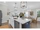 Open concept kitchen with stainless appliances, large island, and seating flowing into the living area at 779 Forrest Dr, Charleston, SC 29492