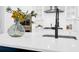 Close-up of the kitchen island featuring a floral display and a matte black kitchen faucet at 779 Forrest Dr, Charleston, SC 29492