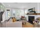 Cozy living room featuring a fireplace with mantel, hardwood floors, and plenty of natural light at 779 Forrest Dr, Charleston, SC 29492