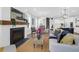 Open-concept living room with a fireplace, dining area, and access to the modern kitchen at 779 Forrest Dr, Charleston, SC 29492