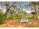 Park area featuring a white bench under shady trees with a scenic marsh view beyond at 779 Forrest Dr, Charleston, SC 29492