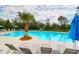 Community swimming pool featuring lounge chairs, palm trees, and umbrellas offering a luxurious outdoor retreat at 779 Forrest Dr, Charleston, SC 29492