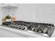 Stainless steel stovetop in a modern kitchen with white cabinets and subway tile backsplash at 779 Forrest Dr, Charleston, SC 29492