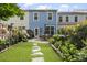 Lovely backyard features stone pavers, lush gardens, patio seating, and private fence at 826 Bibury Ct, Charleston, SC 29414