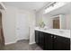 Neutral bathroom with a double sink vanity, large mirror, and decorative plants at 826 Bibury Ct, Charleston, SC 29414
