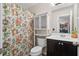 Full bathroom featuring a shower with floral curtain, a sink, and storage at 826 Bibury Ct, Charleston, SC 29414
