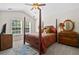 Traditional bedroom with canopy bed, ceiling fan, carpet, and ample natural light from two windows at 826 Bibury Ct, Charleston, SC 29414