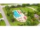 Aerial view of a community pool surrounded by green space, trees, and lounge chairs at 826 Bibury Ct, Charleston, SC 29414