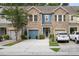 Attractive townhome featuring a stone facade, blue accents, and well-maintained landscaping at 826 Bibury Ct, Charleston, SC 29414