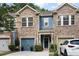 Charming townhome with stone facade, blue accents, two-car garage, and manicured landscaping at 826 Bibury Ct, Charleston, SC 29414