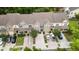 Aerial view of townhomes with attached garages, manicured lawns, and ample parking at 826 Bibury Ct, Charleston, SC 29414