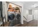 Convenient laundry closet with front-load washer and dryer and overhead storage for cleaning supplies at 826 Bibury Ct, Charleston, SC 29414