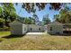 View of the home's rear exterior featuring a patio area with a hammock for relaxation at 8562 N Highway 17, McClellanville, SC 29458