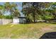 Serene backyard featuring a storage shed, mature trees, and ample green space at 8562 N Highway 17, McClellanville, SC 29458