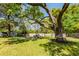 Large backyard with mature trees, a patio with fire pit, and plenty of room to relax at 8562 N Highway 17, McClellanville, SC 29458