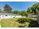 Expansive green backyard, featuring a separate building, offers ample space for activities and outdoor enjoyment at 8562 N Highway 17, McClellanville, SC 29458