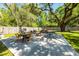 Expansive concrete patio with fire pit, dining, and lounging areas in a private backyard at 8562 N Highway 17, McClellanville, SC 29458