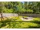 Lush backyard oasis featuring a hammock, fire pit, and ample space for outdoor enjoyment at 8562 N Highway 17, McClellanville, SC 29458