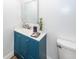 Cozy bathroom featuring a blue vanity, sink, mirror, and toilet at 8562 N Highway 17, McClellanville, SC 29458