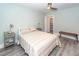 Bright bedroom with gray wood-look flooring, beige walls, and organized closet at 8562 N Highway 17, McClellanville, SC 29458