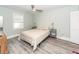 Well-lit bedroom features a ceiling fan, neutral walls, and gray wood-look flooring at 8562 N Highway 17, McClellanville, SC 29458