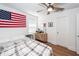 Well-lit bedroom features wood laminate flooring, simple decor, and a ceiling fan at 8562 N Highway 17, McClellanville, SC 29458