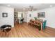 Open concept dining room with views into the kitchen and living room and light wood floors at 8562 N Highway 17, McClellanville, SC 29458