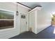 Exterior entrance featuring a charming door and window, set under a covered patio at 8562 N Highway 17, McClellanville, SC 29458