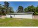 The side of the light green home reveals a pristine roof, well-kept lawn, and functional AC unit at 8562 N Highway 17, McClellanville, SC 29458