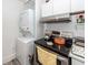 Kitchen area featuring modern appliances, white cabinets, and convenient laundry setup at 8562 N Highway 17, McClellanville, SC 29458
