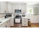 Kitchen with gray cabinets, stainless steel appliances, and white countertops at 8562 N Highway 17, McClellanville, SC 29458