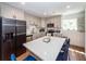Eat-in kitchen with gray cabinets, stainless steel appliances, and a white quartz island at 8562 N Highway 17, McClellanville, SC 29458
