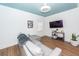 Bright living room with a gray sectional couch, wood floors, a blue ceiling, and white walls at 8562 N Highway 17, McClellanville, SC 29458