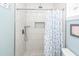 Walk-in shower featuring white marble-look tile, rainfall shower head, and soap niche at 8562 N Highway 17, McClellanville, SC 29458