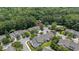 Aerial view of a townhouse community with tree-lined streets and easy access to a community pool at 8743 Grassy Oak Trl, North Charleston, SC 29420