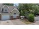Charming townhome featuring a brick facade, attached garage, and well-maintained landscaping at 8743 Grassy Oak Trl, North Charleston, SC 29420