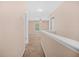 Upstairs hallway with neutral colored walls and carpet flooring at 8743 Grassy Oak Trl, North Charleston, SC 29420