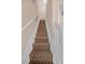 Carpeted stairway with white risers and a matching white handrail at 8743 Grassy Oak Trl, North Charleston, SC 29420