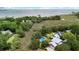 Aerial view showcasing the home's setting amongst lush greenery, waterways, and a sparkling pool at 910 Kushiwah Creek Ct, Charleston, SC 29412