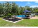 Inviting backyard with a pool, firepit, outdoor seating, and well-manicured lawn with lush landscaping at 910 Kushiwah Creek Ct, Charleston, SC 29412