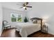 Cozy bedroom with hardwood floors, a plush bed, and a large window for natural light at 910 Kushiwah Creek Ct, Charleston, SC 29412