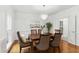 Bright dining room with hardwood floors, elegant chandelier, and stylish upholstered chairs at 910 Kushiwah Creek Ct, Charleston, SC 29412