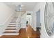 Bright foyer with hardwood floors, a staircase, and an inviting atmosphere at 910 Kushiwah Creek Ct, Charleston, SC 29412