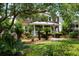 Charming home with manicured lawn, mature landscaping, and welcoming front porch and American flag at 910 Kushiwah Creek Ct, Charleston, SC 29412