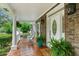 Charming front porch with rocking chairs, decorative plants, and a welcoming entrance at 910 Kushiwah Creek Ct, Charleston, SC 29412